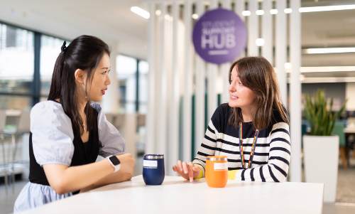 Female student talking to support worker